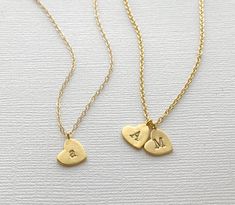 A beautiful heart necklace hand-stamped with your choice of letter initials. This multiple heart initial necklace is perfect for moms, mothers, grandma, grandmothers, girlfriends, wife, wives etc. Carry your loved ones with you wherever you go! Matte Gold 10mm gold-plated hearts, hand stamped with your choice of uppercase or lowercase letters. Choose between a gold plated or 14k gold filled chain. DETAILS: - 10mm heart stamped with UPPERCASE or lowercase initials - Matte Gold finish - Hand-stamp Double Heart Necklace With Initials For Mother's Day, Double Heart Charm Necklaces For Mother's Day, Heart Pendant Charm Necklaces For Mother's Day, Double Heart Initials Necklace For Mother's Day, Heart Shaped Initial Necklace For Mother's Day, Heart Pendant Initials Necklace For Mom, Mother's Day Initial Pendant Charm Necklace For Anniversary Gift, Mother's Day Initial Pendant Heart Necklace With Initials, Mother's Day Gift Initials Charm Necklaces