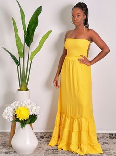 You'll be walking on sunshine all summer long in this darling mustard yellpw pleated smocked maxi dress! We're loving the maxi length (fully lined by the way), elasticated tube top shirring and flattering multi-strap back. You'll kill this with a pair of nude sandals and your fave hand bag CONTENT & CARE Hand wash with cold water Polyester DEETS & FIT Model is wearing a size Medium Fabric has some stretch in the top smocked area Model profile: Uche is 5'9" and measures 34 (bust) 27 (waist) and 4 Ruched Sundress For Beach Season Day Out, Strapless Midi Dress With Smocked Back For Summer, Fitted Maxi Dress With Ruched Bodice For Beach, Summer Bandeau Flowy Maxi Dress, Flowy Bandeau Maxi Dress For Summer, Spring Bohemian Bandeau Maxi Dress, Flowy Maxi Length Smocked Dress For Vacation, Bohemian Bandeau Maxi Dress For Spring, Ruched Maxi Dress For Vacation