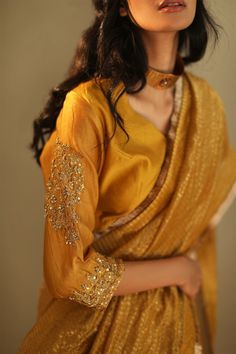 Ochre semi-stitched saree blouse with embroidered sleeves.
Components:1
Embroidered
Sleeve Length:Three quarter
Fabric:Chanderi 
Color:Yellow
Note: Saree worn by the model is not for sale - Aza Fashions Saree Blouses Online, Women Saree, Indian Saree Blouse, Indian Saree Blouses Designs, Gold Blouse, Saree Blouses, Designer Outfits, Elegant Saree, Indian Clothing