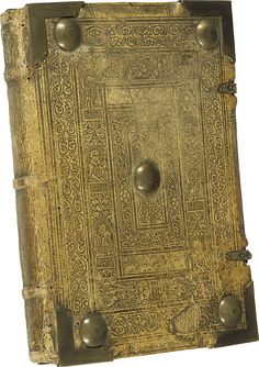 an old book with metal fittings on the front and back cover is shown in gold