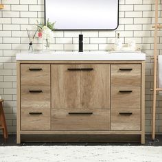 a bathroom vanity with a mirror above it