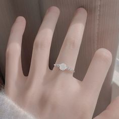 This White Rose Ring screams romance with its beautifully detailed rose design. Say "I love you" in a unique and elegant way with this delicate ring! ◆ Materials: 18k white gold plating Hypoallergenic solid sterling silver base Eco resin Cubic zirconia stones ◆ Size: Adjustable open design for size 5+ ◆ Please Note: When adjusting the ring, please squeeze or expand the ring body slowly and gently. Eco Resin, Rose Ring, Open Design, Hair Accessories Jewelry, Delicate Rings, Say I Love You, Rose Design, Holiday Collection, White Rose