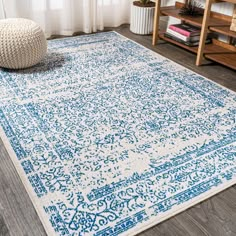 a blue and white area rug in a living room