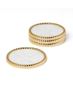 two white marble and gold - plated coasters