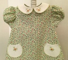 "Sweet little Dress, Size 1. The Dress is  100% Cotton and has a  Poly Cotton Peter Pan Collar and Fully lined READY TO SHIP!   It is truly a comfortable little dress.  The lining helps to keep wrinkles to a minimum and looking fresh.  It measures 9\" across the shoulders and 18\" long. It is handmade, including the embroidery on the Peter Pan Collar and little pockets. Easy to secure with buttons in the back. The Fabric is 100% Cotton. Contact me with any questions!" Cute Smocked Short Sleeve Dresses, Cute Green Smocked Dress, Cotton Smock Dress With Peter Pan Collar, Baby Girls Dresses, 60s Mod, Baby Sister, Smocked Dress, Little Dresses, Ship It