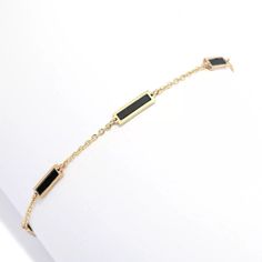 Add a gorgeous splash of color and style to any look with this Sabrina Designs bracelet. It beautifully displays six 7.5mmx1.65mm rectangular gemstone inlays. Choose from turquoise, malachite, mother-of-pearl or onyx. It's crafted in 14K yellow gold with a polished finish that provides brilliant shine. The 7" cable link chain safely secures with a spring ring clasp. It's the perfect finishing touch whenever you want to add eye-catching color to your look, whether you're going casual or dressing Elegant Rectangular Bracelets With Polished Finish, Modern Gold Bracelets With Black Enamel, Elegant Adjustable Jewelry With Rectangular Stone, Elegant Black Jewelry With Rectangular Links, Luxury Rectangular Gold Bracelet, Elegant Black Jewelry With Bracelet Strap, Elegant Black Enamel Bracelet For Formal Occasions, Elegant Formal Black Enamel Bracelets, Elegant Bracelet With Rectangular Stone For Gift