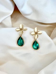 Enhance your elegance with our Green Teardrop Flower Earrings. These dainty and graceful accessories bring a touch of nature's beauty to your ensemble. Delicate gold flowers and a green crystal teardrop make them perfect for any occasion, from casual gatherings to special events. Handcrafted with care, these earrings are a delightful addition to your jewelry collection, offering a unique blend of charm and sophistication." * Crystals Gold flower earrings, green bridesmaid earrings, teardrop earrings, boho bridal earrings, whimsical earrings, woodland wedding, wedding gift Handmade Elegant Flower Teardrop Earrings, Elegant Handmade Flower Teardrop Earrings, Green Teardrop Dangle Earrings For Wedding, Elegant Flower Teardrop Earrings For Gift, Elegant Green Flower Earrings For Gift, Elegant Green Flower Earrings For Wedding, Elegant Handmade Flower Shaped Teardrop Earrings, Dainty Earrings For Wedding With May Birthstone, Green Teardrop Earrings For Wedding