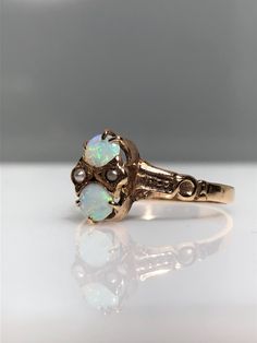 14K  yellow gold antique opal ring from the 1900's. I absolutely love antique finds. This one stuns with its two cabochon cut opals. I'm always intrigued by vintage opals because they are just so much prettier than modern opals. These stones are definitely the original ones! On each side of the opals there are two delicately set seed pearls. Just the tiniest things that are almost over-looked but so appreciated once you see them. The prongs are claw-footed and have been tightened by my jeweler. The finger size is 5.5 Resizing, if needed, comes complimentary. Feel free to message me if you have any other questions. Vintage Opal Rings, Antique Opal Ring, Opal Ring Vintage, Seed Pearl Ring, Antique Finds, Seed Pearl, Opal Ring, Opal Rings, Pearl Ring