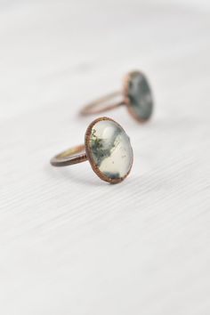 Are you a free spirit looking for green moss agate jewelry? This large moss agate ring is a perfect addition to your agate crystal ring collection. The moss agate stone ring is made with electroformed copper and has the crystal meaning of restoration, optimism, and being nature-bound. Click through to see this oval moss agate ring! Nature-inspired Agate Rings With Natural Inclusions, Handmade Agate Rings With Nature-inspired Style, Handmade Agate Rings In Nature-inspired Style, Handmade Oval Moss Agate Ring, Nature-inspired Moss Agate Rings, Nature-inspired Moss Agate Round Rings, Nature-inspired Adjustable Oval Rings, Adjustable Oval Nature-inspired Rings, Ring Moss Agate