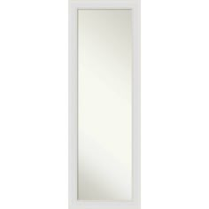 a white door with a mirror on the front and bottom panel, in an empty room