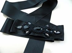 Black crystal sash, black belt for wedding dress, black satin belt for women, crystal belt, embroidered belt women, wedding belt ribbon.Hand embroidered belt with crystals on satin ribbon. An elegant accessory suitable for embellishing an evening dress or an unconventional wedding dress. Each of my creations is handmade after a careful study of shapes and colors. A unique piece created just for you!Length: 78.74 inchIt will be sent in a gift box.For any information do not hesitate to contact me! Luxury Black Embroidered Belt, Elegant Adjustable Sash For Formal Occasions, Elegant Black Belt For Evening, Elegant Adjustable Sashes For Formal Occasions, Elegant Formal Adjustable Sash, Elegant Formal Adjustable Sashes, Formal Black Embroidered Belt, Elegant Ribbon Sashes As Gifts, Elegant Embellished Party Sash