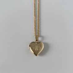 A child's plain polished 14K yellow gold-filled heart-shaped locket on a cable chain necklace. The outer shell is solid gold pressure-bonded to an inner core of high-quality brass. Locket Dimensions: 13 mm W x 21 mm H Chain Length: 15" Classic Yellow Gold Locket Necklace With Heart Charm, Classic Heart Shaped 14k Gold Locket Necklace, Classic 14k Gold Heart Locket Necklace, Heart-shaped 14k Yellow Gold Locket Necklace, Heart Shaped 14k Yellow Gold Locket Necklace, 14k Yellow Gold Heart Locket Necklace, Gold Heart Pendant Locket Necklace With Hallmark, Gold Heart Locket Necklace In 14k Gold, 14k Gold Locket Necklace With Heart Charm For Keepsake