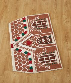 a brown and white area rug on top of a wooden floor next to a wood floor