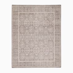 a rug with an intricate design on the front and side, in light grey tones