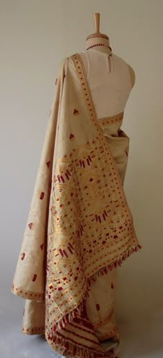 "This is hundred percent authentic Muga Silk Saree . It has Muga silk in the warp and weft . The interwoven motif yarns are in Guna ( golden zari ) and Acrylic. The design is traditional and can be considered as bridal . Muga Silk - The most valued silk from India. Almost exclusively reared and produced in Assam, India. It is indigenous to the Brahmaputra Valley and assiduously practiced in the districts of Assam. The moth is basically a wild moth. Hence it is categorised as Vanya Silk or Wild s Luxury Tussar Silk Pre-draped Saree With Dupatta, Luxury Traditional Silk Scarf With Zari Work, Luxury Cotton Silk Saree With Gota Work, Luxury Handloom Dola Silk Traditional Wear, Luxury Jamawar Traditional Wear With Zari Weaving, Luxury Bohemian Katan Silk Saree, Ceremonial Gold Tussar Silk Traditional Wear, Gold Silk Dupatta With Woven Motifs, Gold Art Silk Dupatta With Woven Motifs