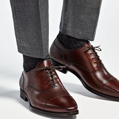 These classic brown Oxfords are crafted from supple calf leather in a flexible Blake stitch, and feature full leather lining and sole. Brown Goodyear Welted Almond Toe Oxfords, Calf Leather Cap Toe Oxfords With Branded Insole, Brown Goodyear Welted Cap Toe Leather Shoes, Brown Cap Toe Leather Shoes With Rubber Sole, Brown Leather Cap Toe Shoes With Rubber Sole, Semi-formal Calf Leather Dress Shoes With Round Toe, Fitted Leather Boots For Semi-formal Occasions, Brown Calf Leather Oxfords With Brogue Detailing, Timeless Brown Oxfords For Business Casual