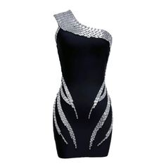 Elevate your style game with our One Shoulder Rhinestone Detail Bandage Mini Dress. Featuring a sleek black design and eye-catching rhinestone detailing, this dress is perfect for any special occasion. The one-shoulder design adds a touch of elegance, while the bandage material flatters your figure for a confident look. Fabric: Medium Stretch Material: Polyester, Spandex Glamorous Black Bandage Dress For Party, Glamorous Black Bandage Dress For Night Out, Glamorous Black Bandage Dress For Club, Party Mini Dress With Rhinestones In Black, Black Mini Dress With Rhinestones For Party, Fitted Black One-shoulder Sequin Dress, Stretch Dresses With Rhinestones For Party, Black Sequin Bodycon Dress For Prom, Embellished Black Bodycon Dress For Prom