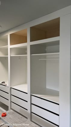 an empty walk in closet with drawers and shelves