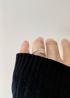 Crafted for elegance and simplicity, this Sleek Sterling Silver Open Band Ring showcases a Contemporary Matte Finish, embodying adjustable minimalism at its finest.  The open band design provides a custom fit for any wearer, while its sterling silver composition ensures lasting shine and durability.  Perfect for those who appreciate modern, understated jewelry, this ring comes in a branded organic cotton pouch, ideal for gifting or as a timeless addition to your collection. To find your size, me Adjustable Minimalist Rings For Everyday Wear, Modern Adjustable Rings For Everyday, Modern Adjustable Stackable Rings With Open Band, Adjustable Modern Midi Rings, Minimalist Open Band Stackable Rings As Gift, Minimalist Open Band Stackable Rings For Gift, Minimalist Open Band Stackable Rings Gift, Minimalist Stackable Open Rings For Everyday, Modern Adjustable Stackable Rings With Simple Design