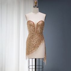 5-7 weeks processing and shipping time This design is from the Bellezza collection. Looking for a dress to make a statement? This copper/gold sequin and tassel mini dress is perfect! This dress is perfect for a birthday party, clubbing, night out or any glamorous occasion.Color may vary due to lighting Material: rhinestones, mesh, polyester Care: hand wash or dry clean only Club Mini Dress With Fringe For Party Season, Party Mini Dress With Fringe, Cocktail Mini Dress With Fringe For Party Season, Evening Mini Dress With Fringe For Party Season, Party Fringe Mini Flapper Dress, Fringe Mini Flapper Dress For Parties, Night Out Mini Dress With Beaded Fringe, Elegant Flapper Dress For Club And Party Season, Glamorous Beaded Fringe Mini Dress For Night Out