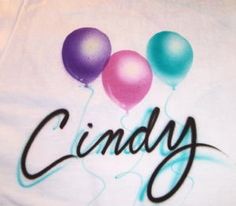 three balloons with the word candy on them are in front of a white t - shirt