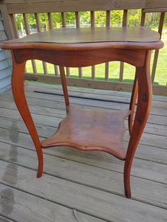 a wooden table sitting on top of a porch