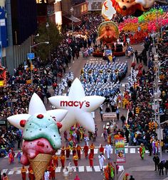 the macy's balloon floats are being paraded down the street in front of spectators