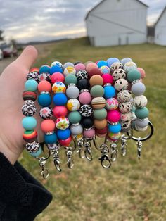 a hand holding a bunch of different colored beads