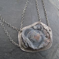 "Large Druzy Pendant Chalcedony Rose Necklace Sparkling Raw Gemstone Neckpiece: This is a stunning, one-of-a-kind neckpiece featuring a natural, raw, sparkling Chalcedony \"rose\" also known as \"Desert Rose\", is hand set on a stamped backplate and suspended from a sterling silver chain that's approximately 18 3/4\" in length. The stone is a sparkly gray with hints of pale blue and cream. Pendant measures approximately 1 1/2\" by 1 3/4\". All handmade in my little home studio. Enter my shop: ht Solder Jewelry, Soldering Jewelry, Rose Necklace, Desert Rose, Layering Necklace, Raw Gemstones, Sterling Silver Chain, Pale Blue, Druzy