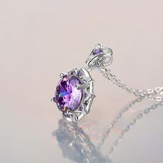 Sparkling and elegant, this purple necklace is perfect for that special evening out. Created in sterling silver, it features a round cut stone sparking at its center, while additional round stones line the sterling silver settings for extra shimmer. An imaginative look you'll adore, this necklace is unsurpassed with magnificence and sparkle.Carat Weight: 8.5 ctStone Size: 11 mmStone Type: Jeulia® StoneNumber of Stones: 1 Stone Shape: RoundStone Color: Amethyst PurpleCarat Weight: 2.658 ctStone S Purple Prong Setting Formal Necklaces, Elegant Purple Oval Pendant Necklace, Purple Diamond Necklace Fine Jewelry, Fine Jewelry Purple Diamond Necklace, Purple Diamond Necklace In Fine Jewelry Style, Formal Amethyst Round Pendant Necklace, Silver Amethyst Necklaces For Party, Luxury Purple Necklace For Anniversary, Luxury Purple Necklaces For Anniversary