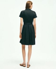 Introducing the ultimate wardrobe essential: the Belted Shirt Dress. Elevate your everyday style with its timeless design and versatile functionality. The pleated bodice and skirt add a touch of sophistication to the classic shirt dress silhouette, while the forward point collar and elongated neckline exude understated elegance. Plus, with the addition of side-seam pockets, this dress seamlessly combines fashion and function. Crafted from 100% cotton, this dress is not only effortlessly chic but Classic Button-up Shirt Dress For Formal Occasions, Classic Midi Dress With Placket For Daywear, Classic A-line Midi Dress With Pleated Waist, Chic Semi-formal Dresses With Box Pleat, Casual Button-up Business Dress, Formal Midi-length Pleated Dress With Box Pleat, Formal Midi-length Box Pleated Dress, Formal Midi Pleated Dress With Box Pleat, Classic A-line Dress With Pleated Back