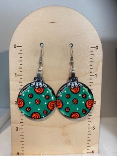 Look at these adorable earrings! These earrings are made using sublimation ink - there is no faux leather or vinyl used.  The design is heat pressed on one side of the precut wood  and permanent. The earrings have an approximate 2.25" drop and are lightweight.   Please allow for slight variances as each pair is made to order Please feel free to message me with any questions! Wooden Christmas Earrings, Ornament Earrings, Holiday Earring, Sublimation Ink, Red Earrings, Wooden Christmas, Christmas Earrings, Green And Red, Wooden Diy