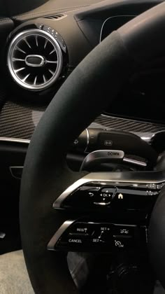 the interior of a car with steering wheel controls