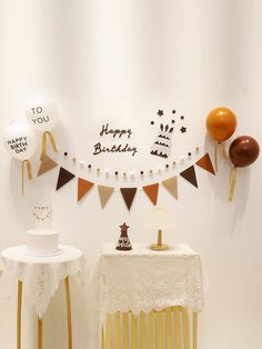 a birthday cake on a table in front of balloons and streamers that say happy birthday