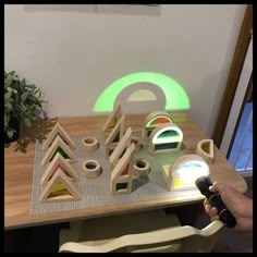 a child's play table with toys on it and a green light coming from the top