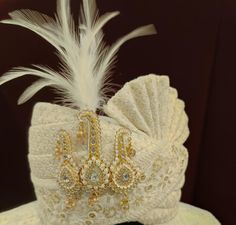 a white hat with feathers and jewels on it