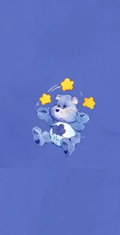 a teddy bear floating in the air with stars on its head and body, surrounded by smaller yellow stars