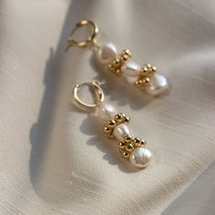 "The Baroque Eyelet Mini Hoop Earrings feature a mini hoop that hugs the earlobe and a genuine baroque pearl dangle with gold or silver signature clustering. They are perfect for everyday wear! Lightweight and comfortable to wear. Wear them two ways - slide the dangle off to wear just the simple hoop earring. \"BAROQUE EYELET MINI HOOP EARRINGS\" by GoldenLinings - Christine Elizabeth Jewelry D E T A I L S Materials: 14K Gold Fill or Sterling Silver Closure: latch hook S I Z E S Measures appox. Gold Pearl Drop Cartilage Earrings, Gold Pearl Drop Cartilage Earrings As Gift, Gold Pearl Huggie Jewelry, Yellow Gold 14k Gold-filled Huggie Pearl Earrings, 14k Yellow Gold-filled Huggie Pearl Earrings, Elegant 14k Gold Filled Hoop Cartilage Earrings, Yellow Gold Pearl Small Hoop Earrings, Small Hoop Pearl Earrings For Gift, Yellow Gold Pearl Huggie Jewelry