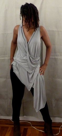 Size S,M,LGray drape top is one of my new tops.    You can wear a sports bra under,bikini top,tank top.  If you would like the arm hole smaller, please let me know.  I love draping tops, because they are stylish for any age,funky,chic and fun to wear.  You can wear leggings,skinny jeans or over any plain dress or skirt.  The fabric in the picture is rayon Lycra (light weight).  I can also make it in ity jersey which is wrinkle free and easy to care for.  Every piece of clothing in my shop is mad Draping Top, Grey Drapes, Drape Top, Plain Dress, Draped Top, Chic And Elegant, Elegant Blouses, Top Tank, New Tops