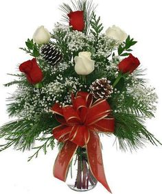 a vase filled with white and red flowers