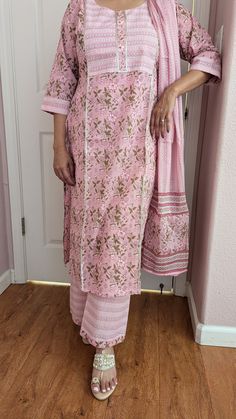 A 100% pure cotton pink printed palazzo suit with dupatta is ideal for summer season. Beautiful print enhance the beauty of this suit . The sleeves are 3/4 and palazzo pant has elastic and belt. This beautiful soft cotton suit is good for summer parties , casual  and special occasions. Floral Print Traditional Wear For Spring Festivals, Floral Print Traditional Wear For Festive Spring, Pink Floral Print Palazzo Set For Navratri, Pink Floral Print Palazzo Set For Eid, Floral Traditional Wear For Festive Spring Season, Bohemian Palazzo Set With Floral Print Straight Kurta, Festive Pink Floral Print Palazzo Set, Spring Pink Floral Print Sharara, Unstitched Pink Kurta With Floral Print