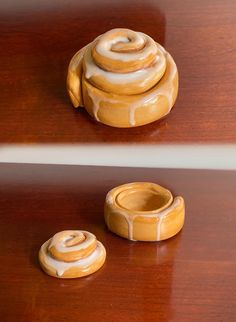 two ceramic objects sitting on top of a wooden table