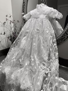 Elegant Lace Embroidered Gown, Elegant Gown With Floral Applique And Lace, Formal Embroidered Lace Dress, Floor-length Lace Gown With Lace Trim, Ceremony Gown With Scalloped Lace, White Lace Baptism Dress With Floral Applique, Ceremonial Lace Gown With Scalloped Lace, Ceremonial Lace Gown With Scalloped Details, Floor-length Lace Gown With Scalloped Lace