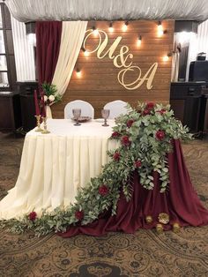 the table is decorated with greenery and candles