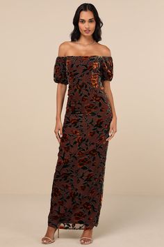 a woman wearing a long dress with an off the shoulder top and floral print on it