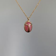 Candied pink rhodochrosite is sweetly embraced by yellow gold. 14k yellow gold Rhodochrosite 8mm x 11mm (5/16" x 1/2")Chain is 16" long Spiritual Gold Necklace With Cabochon, Spiritual Gold Cabochon Necklace, Scarab Amulet, Egyptian Scarab Necklace, Scarab Pendant, Pink Rhodochrosite, Newport Ri, Pink Candy, Newport