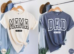 two t - shirts hanging on clothes racks with the word'mama'printed on them