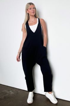 Details: Unwind and look effortlessly stylish with our Relaxed Fit V-Neck Jumpsuit. Made from a soft, solid knit fabric, this baggy jumpsuit offers a casual loose fit for all-day comfort. The sleeveless design, deep V-neck, and raw edge detail add unique touches, while the side pockets provide convenience. Dress it up or dress it down, this jumpsuit is perfect for any occasion!- Pockets - Relaxed fit - V-neck Content: 95% Cotton,5% SpandexSize + Fit: Model is 5'9" (mocha) and wearing a Small - M Solid Color V-neck Jumpsuits And Rompers For Leisure, Casual Fall Loungewear Jumpsuits And Rompers, Casual Fall Jumpsuits And Rompers For Loungewear, Casual V-neck Jumpsuit With Relaxed Fit, Relaxed Fit Athleisure Jumpsuits And Rompers, Relaxed Fit Jumpsuits And Rompers For Athleisure, Relaxed Fit Overalls Jumpsuit For Loungewear, Relaxed Fit Overalls For Loungewear, Oversized Cotton Jumpsuits And Rompers In Solid Color