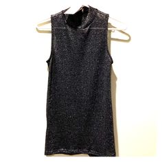 Lightweight Sweater Tank With Silver Detailing That Adds A Sexy Shimmer. This Top Is A Bit Sheer And Can Be Worn With A Bralette/Bandeau/Cami. It Is Tunic Length With Small Slits On The Sides And Can Easily Be Worn With Leggings! Great For A Night Out! Evening Stretch Glitter Tops, Glamorous Fitted Tops With Sheen, Chic Shimmer Stretch Tops, Shimmer Stretch Tops For Night Out, Chic Shimmer Tops For Night Out, Fitted Shimmer Tops For Night Out, Fitted Shiny Tops For Evening, Fitted Shiny Evening Tops, Elegant Shiny Tops For Night Out