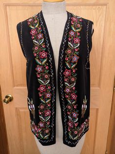 Beautiful black velveteen beaded vest from the 60's in the classic traditional folk design of Romania.  The beaded designs are very colorful and intricate on the front and back, and the vest is fully lined in black rayon.  There is a 1/2" section of beading missing from the left back armhole, but otherwise the vest is in excellent condition.  These vests are Unisex and the measurements are approx: 15" across the shoulders 37" armhole to armhole when closed 38" around the bottom when closed 26" overall length Beaded Vest, Beaded Designs, Folk Design, Vest Outfits, Womens Vest, Romania, Beading, 1960s, Overalls